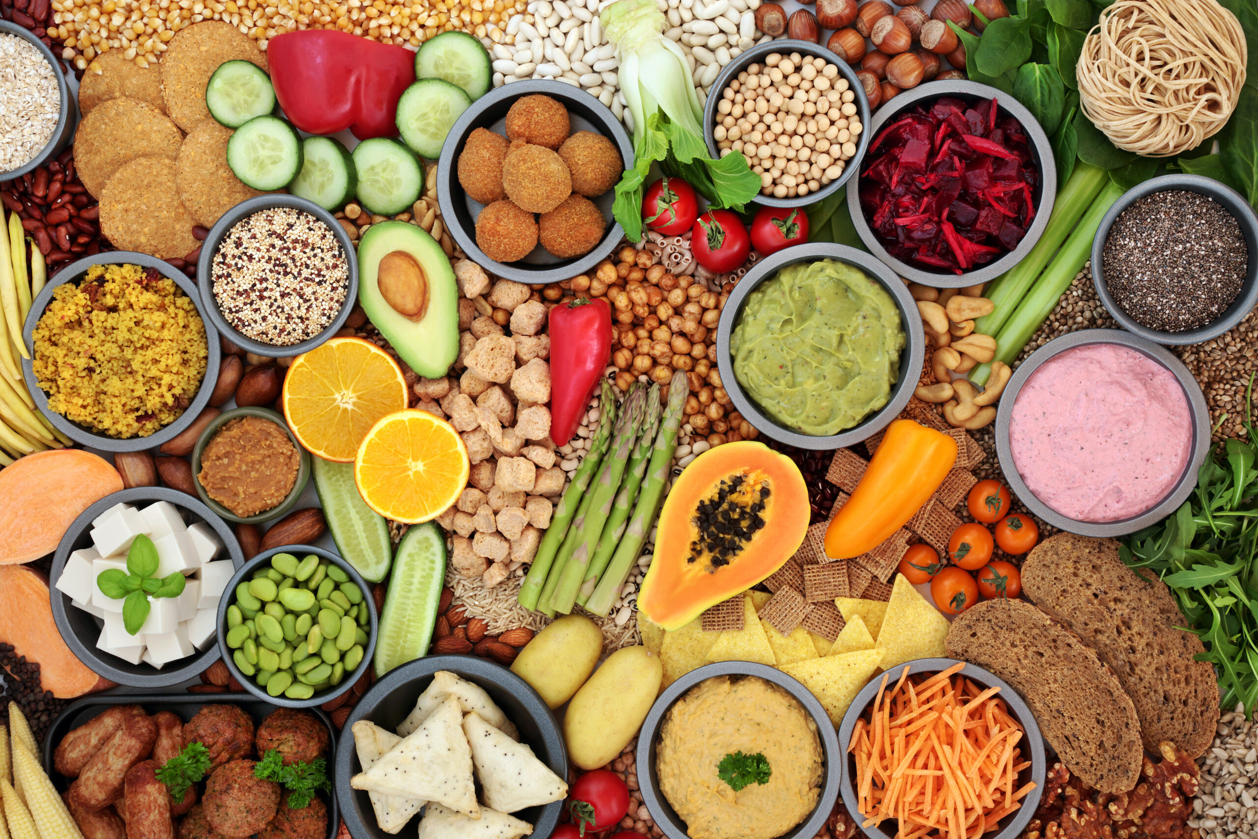 Plant-Based Vegan Food, vegetables, fruit, tofu, cereal, legumes, and dips.