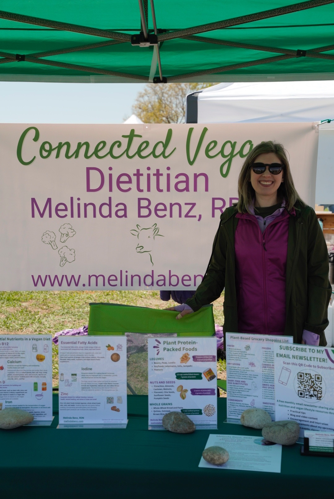Dietitian Melinda Benz Standing at Outdoor Event Booth